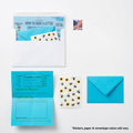Stationery set with blue envelopes, paper, and stickers on a white background